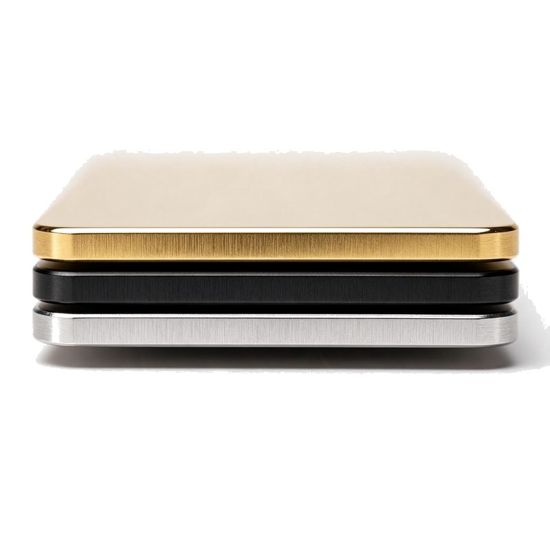 macro of the edges of three stacked metal business cards showing the thin gauge in silver, black and gold
