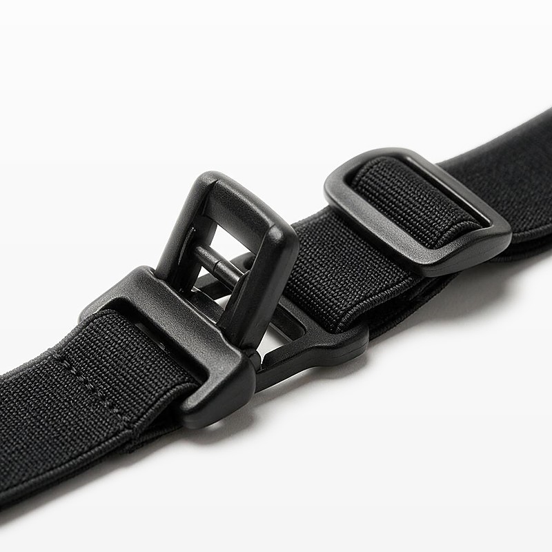 macro of an open press-fit bib toggle and slider on black elastic webbing