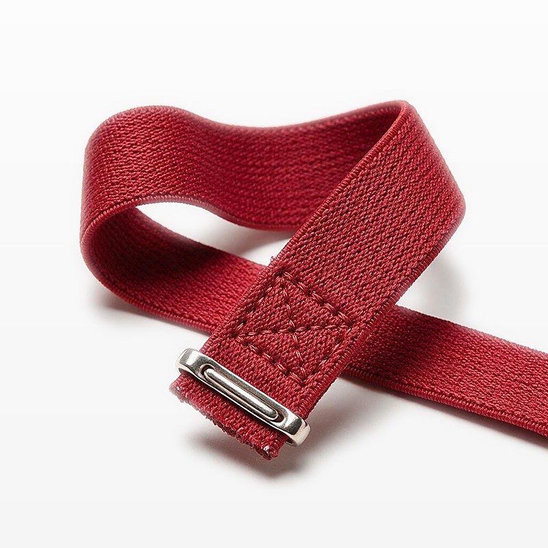 box-stitched end of a crimson elastic race belt with a metal slider