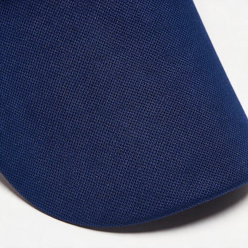 macro of navy polyester piqué fabric showing the knit and light sheen